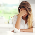 confused woman, holding her forehead