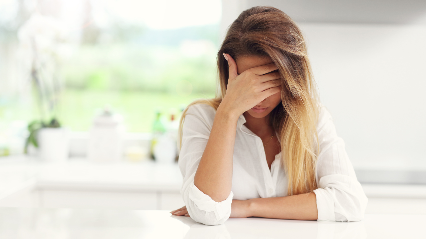 confused woman, holding her forehead