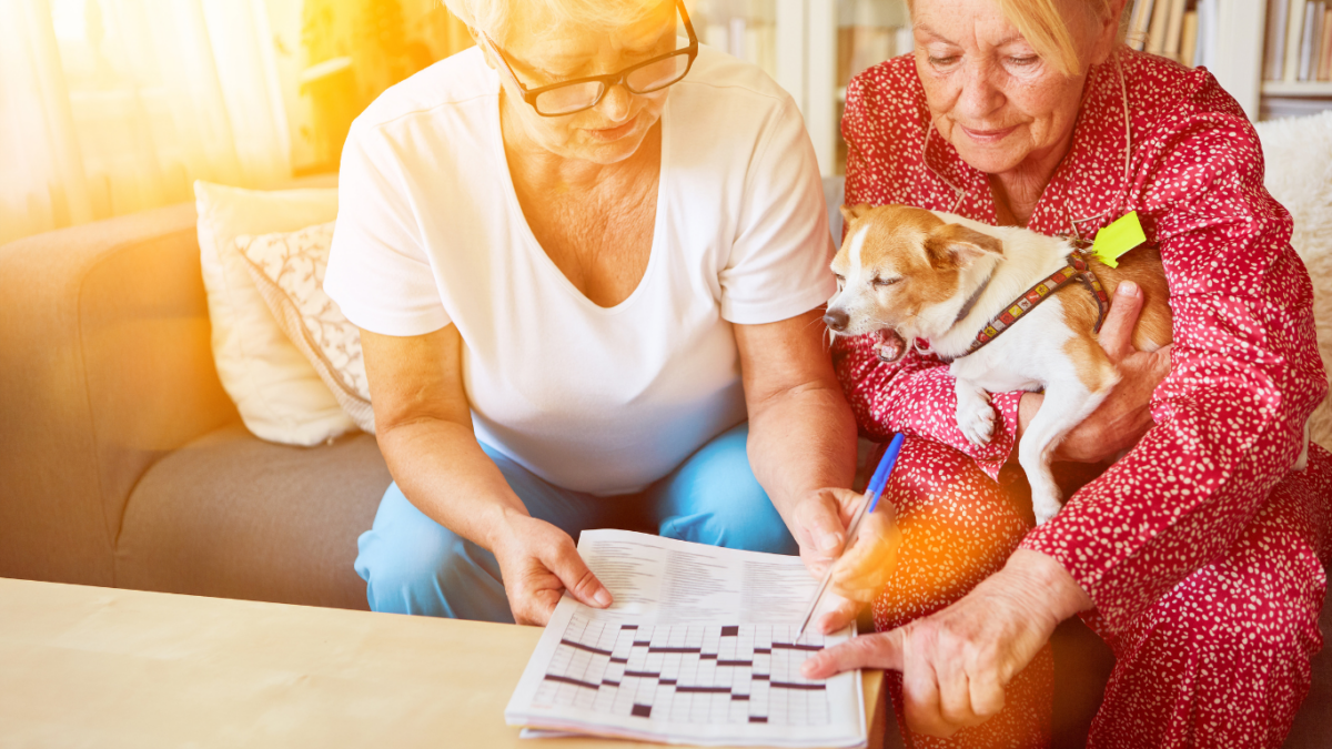 2 older women playing crossword puzzle