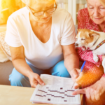 2 older women playing crossword puzzle