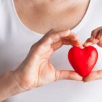 woman holding a heart shape