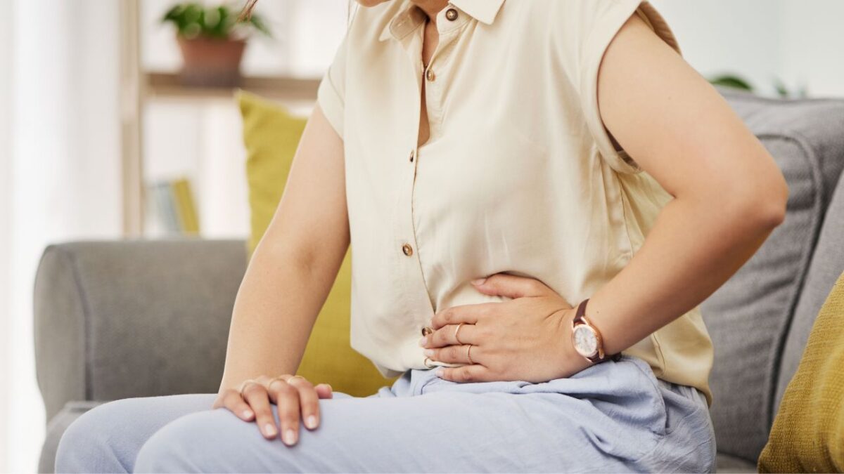 Woman with stomach ache: How to Get Rid of Bloating After Thanksgiving Indulgence