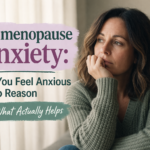 Woman looking anxious by a window with perimenopause anxiety text overlay.